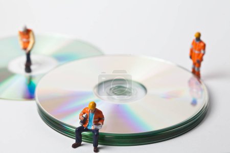 Photo for Miniature people in action with CDs - Royalty Free Image