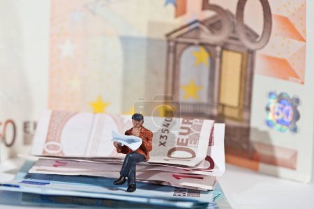 Photo for Miniature people in action with euro banknotes - Royalty Free Image