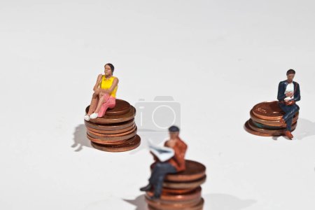 Photo for Miniature people sitting on coins on background, close up - Royalty Free Image