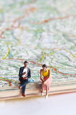 Photo for Miniature people in action on a roadmap - Royalty Free Image