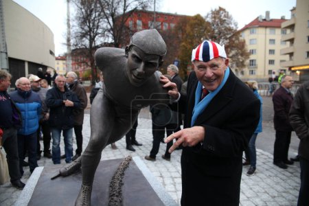 Photo for Knut "Kupper'n" Johannesen poses next to his own statue outside Bislett Stadium in Oslo - Royalty Free Image