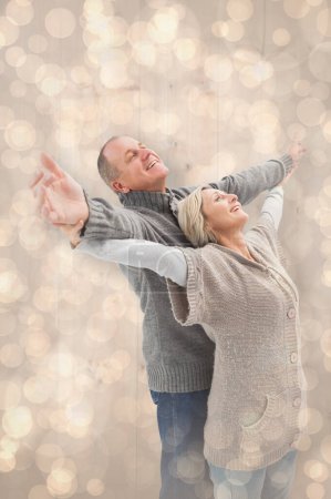 Photo for "Composite image of happy mature couple in winter clothes" - Royalty Free Image