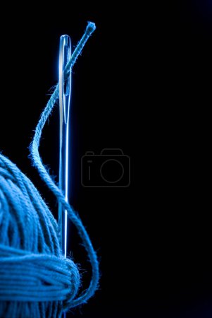 Photo for Needle and fabric on dark background - Royalty Free Image