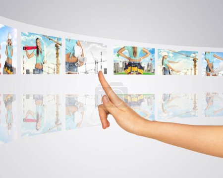Photo for Subject construction. Finger presses one of virtual screens - Royalty Free Image
