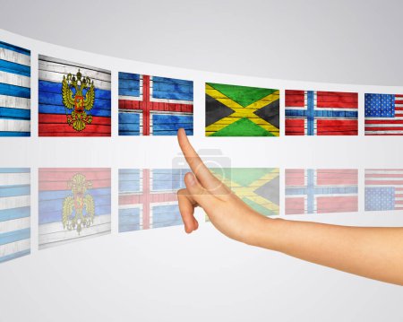 Foto de "Banderas temáticas. Dedo presiona una de las pantallas virtuales" - Imagen libre de derechos