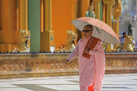 Photo for MANDALAY, MYANMAR- NOVEMBER 24 :Buddhist nun are walking along a street in city on November 24, 2015 in Mandalay,Myanmar - Royalty Free Image