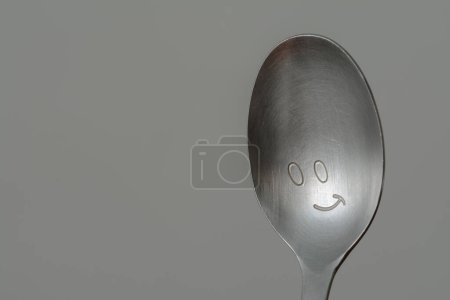 Photo for Smiley Spoon on grey background - Royalty Free Image