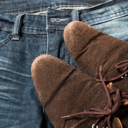 Photo for Leather shoes on jean pants - Royalty Free Image