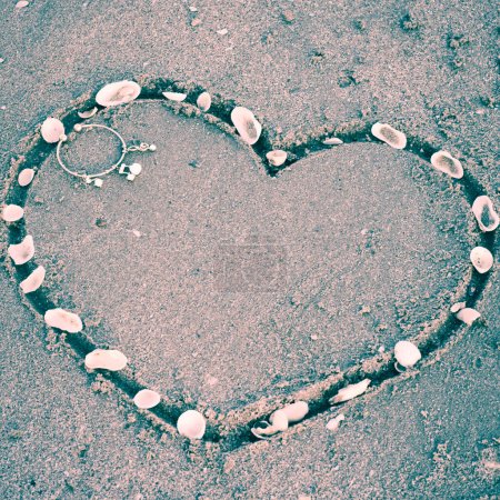 Téléchargez les photos : Un cœur sur le sable de la plage - en image libre de droit