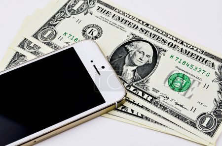 Photo for Smartphone and one dollars banknotes - Royalty Free Image