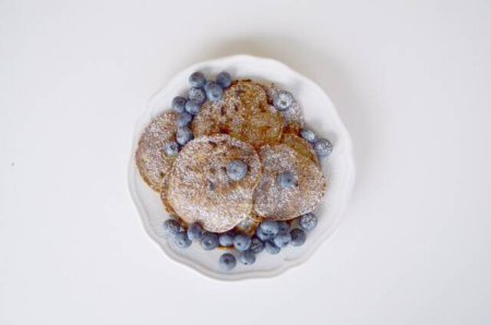 Photo for Homemade pancakes with blueberries and powdered sugar - Royalty Free Image