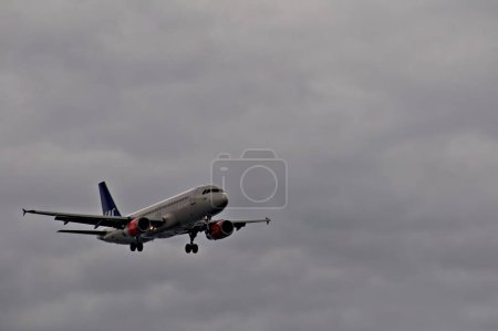 Photo for Airplane in cloudy sky - Royalty Free Image