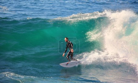 Photo for Young man surfing wave in sea at daytime - Royalty Free Image