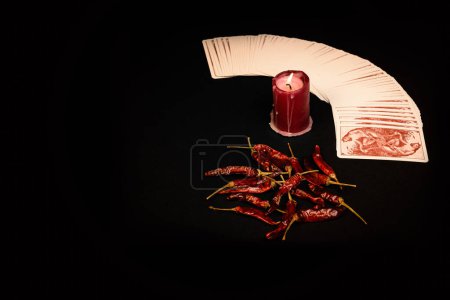 Photo for Red pepper with Taro cards on a dark background - Royalty Free Image