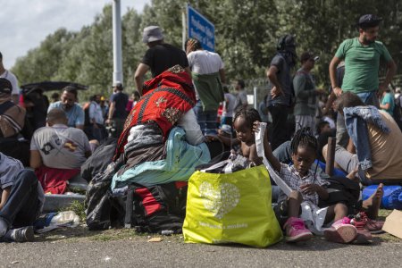 Photo for SERBIA, Horgos: Refugees wait at the Serbia-Hungary border, blocking traffic, after Hungary closed the border crossing on September 16, 2015. - Royalty Free Image