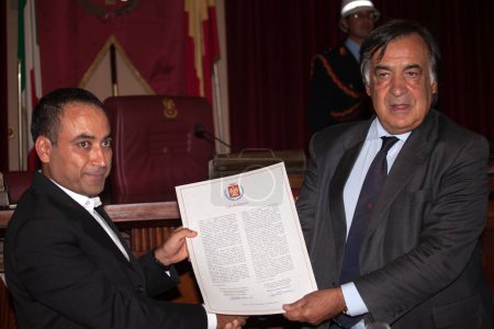 Photo for ITALY, Palermo: Doctors Without Borders cultural mediator Ahmad Al Rousan receives an honorary citizenship from Palermo Mayor Leoluca Orlando on September 16, 2015. - Royalty Free Image