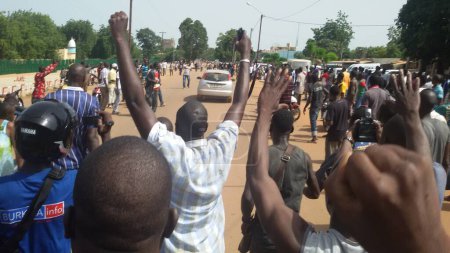 Photo for BURKINA FASO, Ouagadougou : Residents protest near the presidential palace in Ouagadougou on September 17, 2015, after Burkina Faso's presidential guard declared a coup, a day after seizing the interim president and senior government members - Royalty Free Image