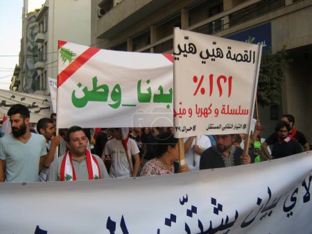Photo for LEBANON, Beirut: A protester carries a sign reading We want a country in Beirut on September 21, 2015 as part of the #YouStink movement rallying against alleged government corruption. - Royalty Free Image