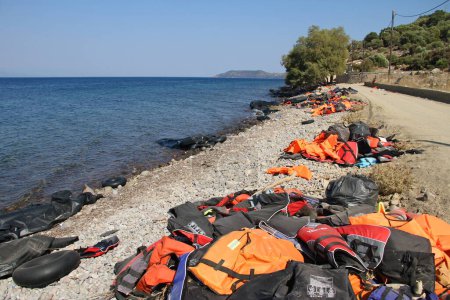 Photo for GREECE, Lesbos: Refugees and migrants arrive in an overcrowded boat to a beach on the Greek island of Lesbos on December 6, 2015. Many of the boats and rafts continue to make the journey from Turkey to Greece each day - Royalty Free Image