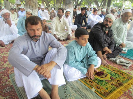 Photo for Pakistan, Peshawar: Muslims celebrate Eid-al-Adha by offering prayers at a mosque in Peshawar, Pakistan on September 25, 2015. - Royalty Free Image