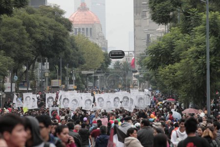 Photo for Mexico, Morelia: Hundreds of people march during a rally marking the one year anniversary since the disappearance of the 43 Ayotzinapa students, in Morelia, Mexico, 26 September 2015 - Royalty Free Image