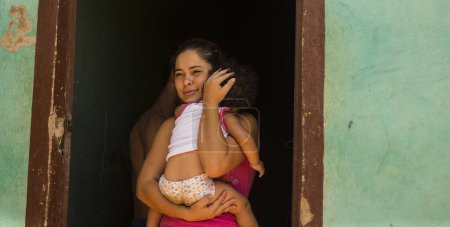 Photo for COLOMBIA, La Parada: Deported from Venezuela over a month ago, a Colombian woman holding a child, on September 26, 2015, now living in a temporary shelter in the La Parada area, near Cucuta, Colombia. - Royalty Free Image