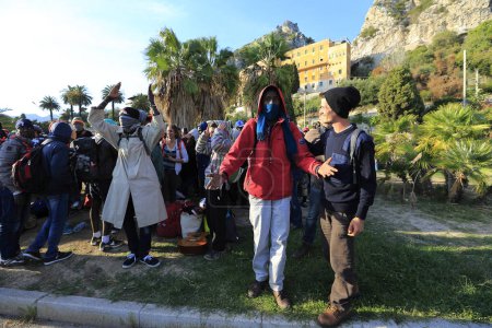 Photo for Italy, Ventimiglia :Evacuating camp, migrants get on bus to be welcomed in Croix-Rouge center in Ventimiglia on September 30, 2015 - Royalty Free Image