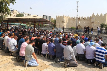 Photo for ISRAEL, Jerusalem: Muslim worshipers gather to pray outside the blocked off mosque in Jerusalem, Israel on October 2, 2015. - Royalty Free Image