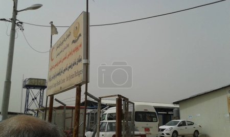 Photo for IRAQ, Kurdistan: Exteriors of a building and a van at the Kawergosk refugee camp in Kurdistan on October 4, 2015.Some cases of cholera appeared in Baghdad and southern Iraq resulting in humanitarian organizations in camp to provide information. - Royalty Free Image