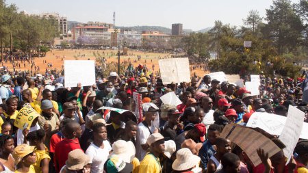 Foto de SUDÁFRICA, Pretoria: Manifestantes huyen de la policía mientras se estima que 10.000 personas se reúnen en los Edificios de la Unión el 23 de octubre de 2015. - Imagen libre de derechos
