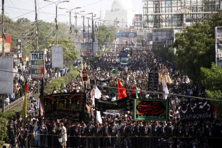 Photo for PAKISTAN, Karachi : Shiite Muslims pray during a Ashura procession to commemorate the martyrdom of Imam Hussain, the grandson of Prophet Muhammad, in Karachi on October 24, 2015 - Royalty Free Image
