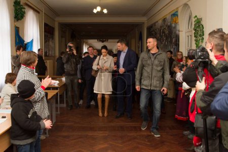 Photo for UKRAINE, Kiev: Kiev's mayor Vitaly Klitschko, his wife Natalia, and brother Vladimir Klitschko prepare to cast their ballots at a polling station in Kiev on October 25, 2015. - Royalty Free Image
