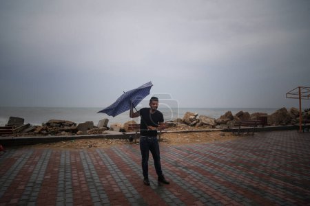 Photo for GAZA STRIP: Stormy weather sweeps into the sea port area near the Gaza Strip causing the streets to flood and damage to some homes on October 25, 2015. - Royalty Free Image