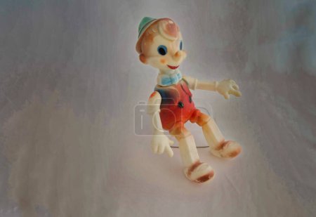 Photo for Figure of Pinocchio on grey background - Royalty Free Image