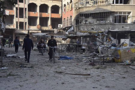 Photo for SYRIA, Douma : Residents inspect damage on the main field hospital in Douma after it was bombed by Syrian government air strikes in Douma, in north-east of Damascus suburb on October 29, 2015. - Royalty Free Image