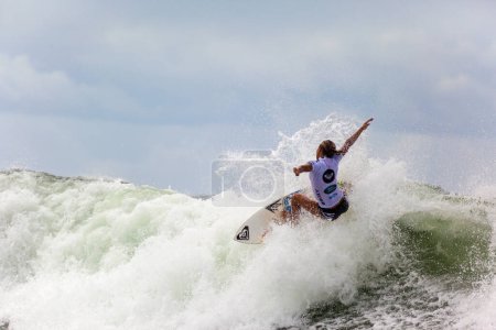 Foto de Surfista femenina en ola en competición - Imagen libre de derechos