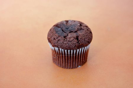 Photo for Chocolate muffin on brown background - Royalty Free Image