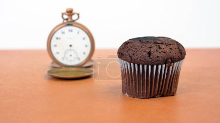Photo for Chocolate muffin and Vintage clock - Royalty Free Image