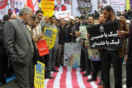 Photo for IRAN, Tehran: Protesters shout 'Down with USA' as hundreds of people march in front of the former US embassy in Tehran, during the '13 Aban' (4th of November in english), on November 4, 2015 - Royalty Free Image