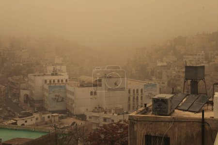 Photo for JORDAN, Amman : A thick sandstorm cloak the Jordan capital city Amman in Othman Bin Affan street and other regions in the Middle East on November 4, 2015, disrupting travel for the US first lady. - Royalty Free Image