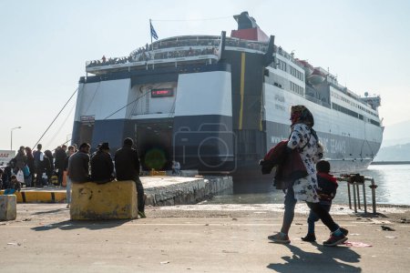 Photo for GREECE, Lesbos: refugees and migrants arrive in an overcrowded boat to a beach on the Greek island of Lesbos on December 6, 2015. Many of the boats and rafts continue to make the journey from Turkey to Greece each day - Royalty Free Image
