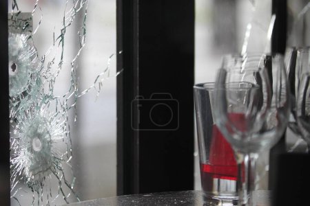 Photo for FRANCE, Paris: Bullet holes and marks are seen on the windows of a cafe on November 14, 2015 in Paris, France. - Royalty Free Image