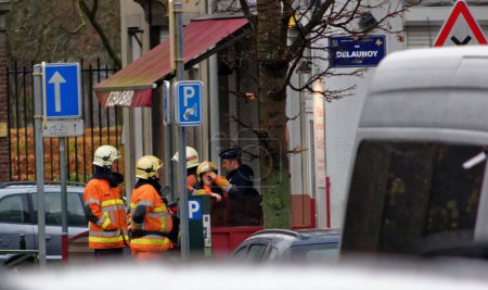Photo for BELGIUM, Brussels: Firefighters are seen in Molenbeek, near Brussels, Belgium on November 16, 2015 during an arrest operation toward a Paris attacks suspect. - Royalty Free Image