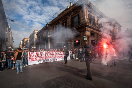 Photo for ITALY, Palermo: A protester lights a flare as hundreds of high school students march from the Piazza Castelnuovo to the Teatro Massimo in Palermo, Italy on November 20, 2015 against the Good School reform bill that passed in July. - Royalty Free Image