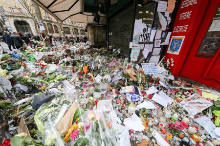 Photo for FRANCE, Paris: Flowers and candles are shown near La belle Equipe cafe on November 21, 2015 in Paris. This cafe is one of the places attacked by terrorists in Paris on November 13, 2015. - Royalty Free Image