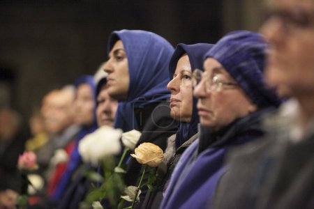 Photo for FRANCE, Paris: Three veiled women attend the service one week following the terrorist attacks, renowned French conductor Hugues Reiner led a 400-strong orchestra and choir in their performance of famous Mozart melodies on November 20, 2015 - Royalty Free Image