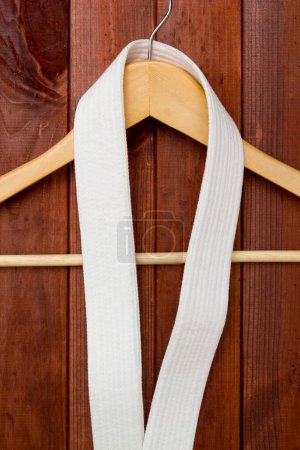 Belt Karate hanging on hanger near wall