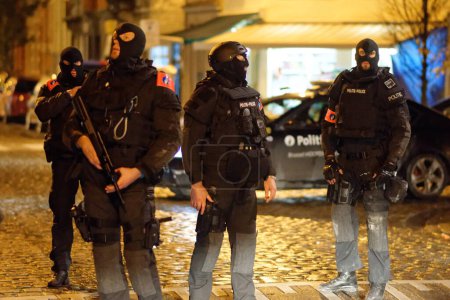Photo for BELGIUM, Brussels: Police stand guard on a security perimeter, in Molenbeek-Saint-Jean, in Brussels on November 22, 2015. - Royalty Free Image