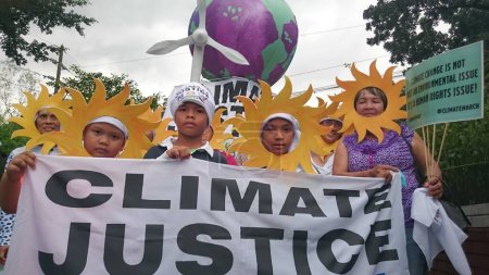 Photo for PHILIPPINES, Quezon City : Protesters attend a climate change march on a highway in Quezon City on November 28, 2015. - Royalty Free Image