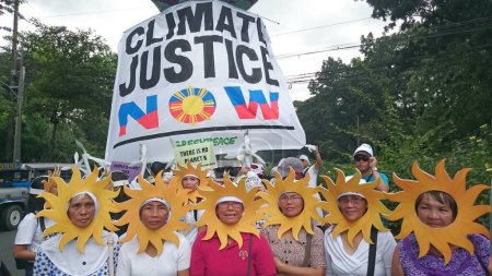 Photo for PHILIPPINES, Quezon City : Protesters attend a climate change march on a highway in Quezon City on November 28, 2015. - Royalty Free Image
